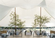 a large tent with tables and chairs set up for an event