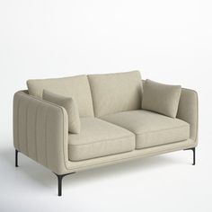 a beige couch sitting on top of a white floor