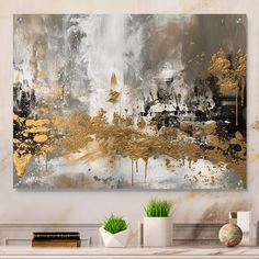 an abstract painting with gold and grey colors on a white wall next to two planters