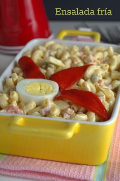 a yellow dish filled with macaroni and cheese