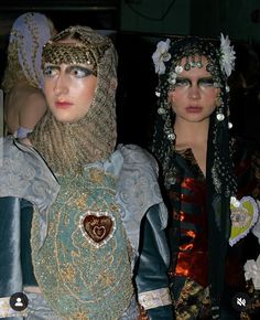 two mannequins dressed in costumes and headdress