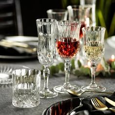 there are many glasses on the table ready to be used for wine or other drinks