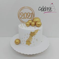 a white cake with gold decorations on top