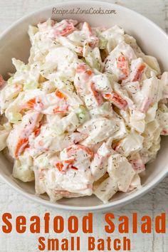 a white bowl filled with salad sitting on top of a table