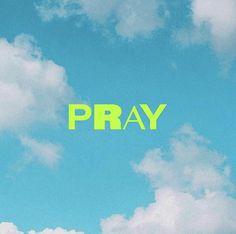 the word pray written in neon green against a blue sky with white puffy clouds