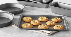 cookies and pans on a table with baking utensils