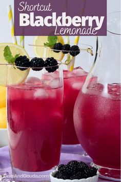 two glasses filled with blackberry lemonade on top of a table