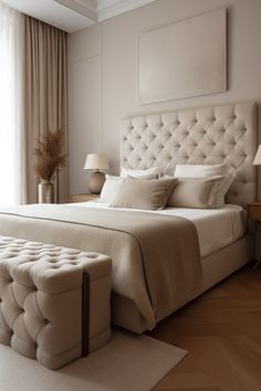 a bedroom with a large bed and white furniture