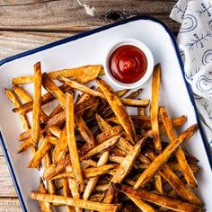 french fries with ketchup on a white plate