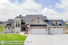 a large house with two garages and lots of windows