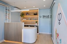 the interior of a medical office with white walls and wooden flooring is lit by recessed lighting