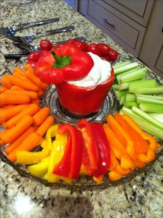 a platter filled with assorted veggies and dip