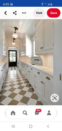 an image of a kitchen with white cabinets and checkered floor