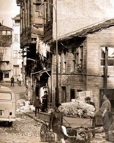 an old black and white photo of people in the street