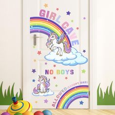 there is a door with a unicorn on it and rainbow wall decals behind it