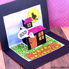 a handmade halloween card with a house