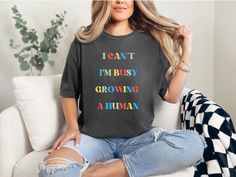 Elevate your maternity wardrobe with our collection of funny pregnancy tees! From clever quotes like "I can't, I'm busy growing a human" to playful designs, these tops are perfect for showcasing your sense of humor during this special time. Whether you're lounging at home or out and about, our maternity tops are designed to keep you comfortable and stylish. Treat yourself or surprise a mom-to-be with the gift of laughter! 🤣💕 #MaternityStyle #PregnancyAnnouncement #BabyBumpFashion #BabyShowerIdeas #BabyAnnouncement #BabyAnnouncementPhotoshoot Maternity Shirts Funny, Cute Maternity Shirts, I’m Pregnant Shirt, Maternity Casual T-shirt With Funny Print, Casual Maternity T-shirt With Funny Text, Funny Pregnancy Shirts, Funny Pregnancy Announcement, Pregnancy Announcement To Husband