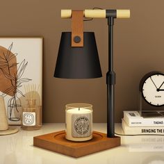 a desk with a lamp, clock and other items on top of the table in front of it