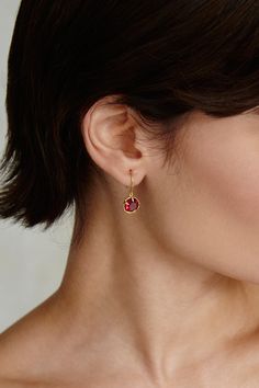 An elegant way to wear your birthstone. Faceted ruby crystals sparkle in these timeless gold hoop earrings. 18k gold plated sterling silver. 1" drop. Handmade in Vietnam. Ruby Stone Earrings Gold, Ruby Hoop Earrings, Single Ruby Earring As A Gift, Elegant Gold Huggie Earrings With Birthstone, Yellow Gold Huggie Earrings With Birthstone For Gift, 14k Gold Birthstone Hoop Earrings, Red Fine Jewelry Hoop Earrings As Gift, Elegant Small Hoop Birthstone Jewelry, Gold Hoop Earrings With Birthstone As Gift