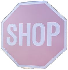 a pink and white stop sign with the word shop written in large letters on it