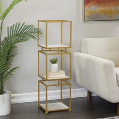 Throw in a few books, a dainty plant, or a sculpture onto this 3-tier corner shelf for a chic and minimalist display organizer in your home space. Designed with gold stoppers at the base that prevent sliding around as well as scratching the floor. This item ships in 1 carton. Suitable for indoor use only. Marble is a product of nature and no two pieces are exactly alike. It is prone to variations in color and/or patterns in the material that add to the beauty and charm of the piece.. Maximum weight limit is 30 lbs each shelf.. This is a single shelving unit. This item comes with 3 marble shelves. Glam style. Grayson Lane Gold Glam Cube Metal 3-Shelf Bookcase (12-in W x 39-in H x 12-in D) Marble | 60527 Marble Shelves, White Shelving Unit, Chic Organization, Gold Shelves, Marble Shelf, Marble Square, Corner Display, Metal Shelving Units, Furniture Bookshelves