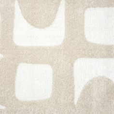 a white rug with squares and circles on it