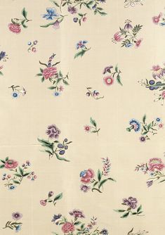 an image of a flowered fabric with many flowers on it's side and green leaves in the middle