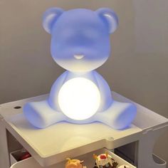 a blue teddy bear sitting on top of a table