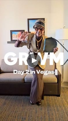 a woman sitting on top of a couch in front of a painting and text that reads grown day 2 in vegas