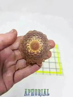 a hand holding an object that looks like a flower