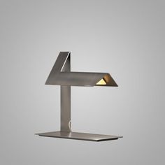 a lamp that is on top of a metal stand with a light in the middle