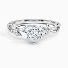 a heart shaped diamond ring with leaves on the band