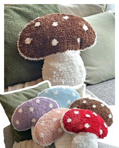 a stuffed mushroom sitting on top of a pillow