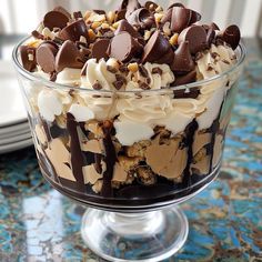 a glass dish filled with chocolate and marshmallows on top of a table