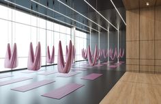 yoga mats lined up in an empty room