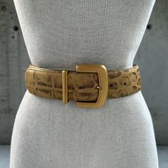 Vintage wide leather belt, 90s gold tone and brown belt, large gold buckle, maximalist fashion statement, sophisticated brutalist style Step into the bold allure of maximalist fashion with our Vintage Wide Leather Belt--a resplendent accessory that epitomizes the essence of sophisticated brutalist style from the vibrant era of the 90s. Crafted with meticulous detail, this belt seamlessly marries gold tone and brown hues in a stunning reptile embossed effect. The wide expanse of the belt boasts a luxurious texture, capturing the eye with its amalgamation of gold and brown tones in a mesmerizing dance of reptilian elegance. The large gold buckle becomes a focal point, a statement piece that adds a touch of opulence and boldness to any ensemble. This accessory transcends mere functionality; i Maximalist Fashion, Wide Leather Belt, Flowing Dresses, Brown Belt, Suspender Belt, Baby Bag, Suspenders, Leather Belt, Fashion Statement