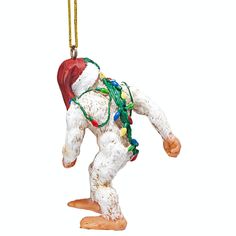 an ornament shaped like a snowman wearing a santa hat and holding a string