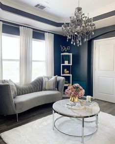 a living room filled with furniture and a chandelier