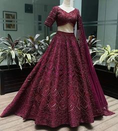 a dress on display in front of a plant