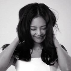 black and white photograph of a woman holding her hair