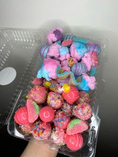 a plastic container filled with lots of different colored candies