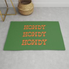 a green rug with the words hondy hondy on it next to a basket