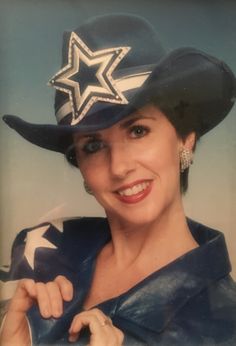 a woman wearing a cowboy hat with stars on it