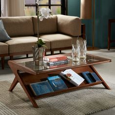 a coffee table with books on it in a living room