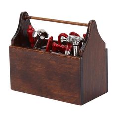 a wooden box filled with lots of red scissors