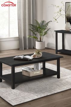 a black coffee table sitting on top of a wooden floor next to a white rug