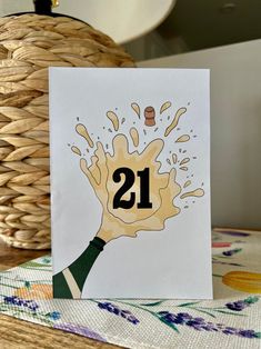 a card with the number 21 on it and a bottle of wine coming out of it