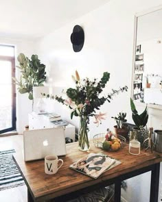 an instagram page with flowers and plants on the table in front of a laptop