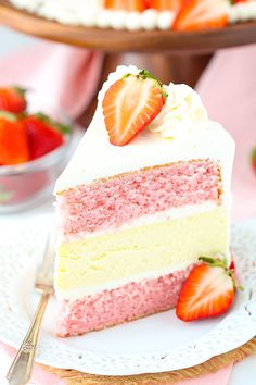 a slice of strawberry cake on a plate with strawberries