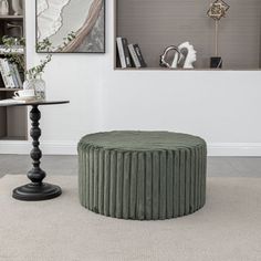 a living room filled with furniture and a round table in the middle of the floor